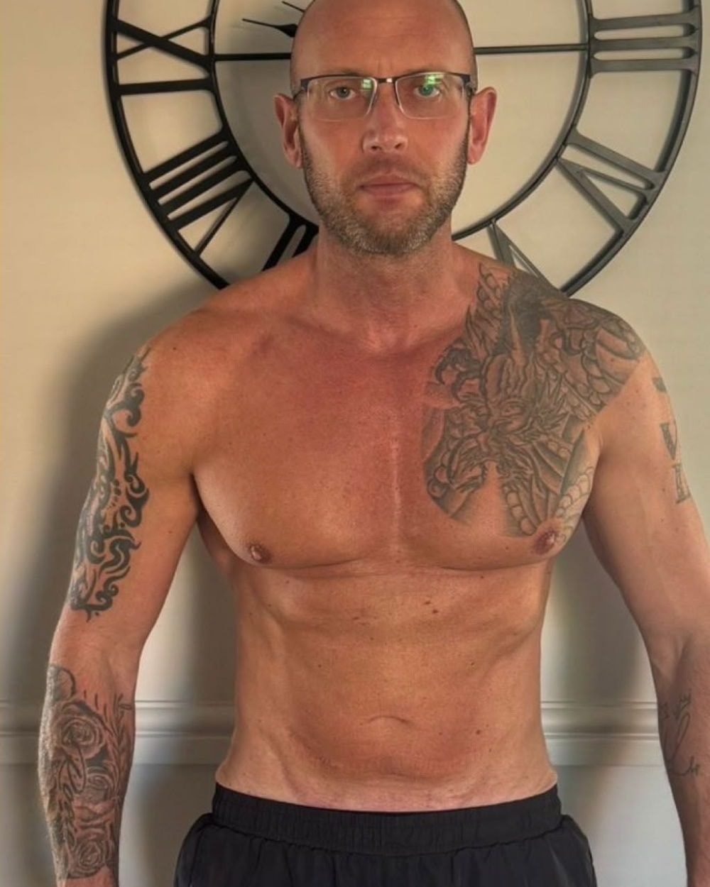 Client 3 after coaching: front relaxed pose, leaner midsection with visible abs and a sharper chest line