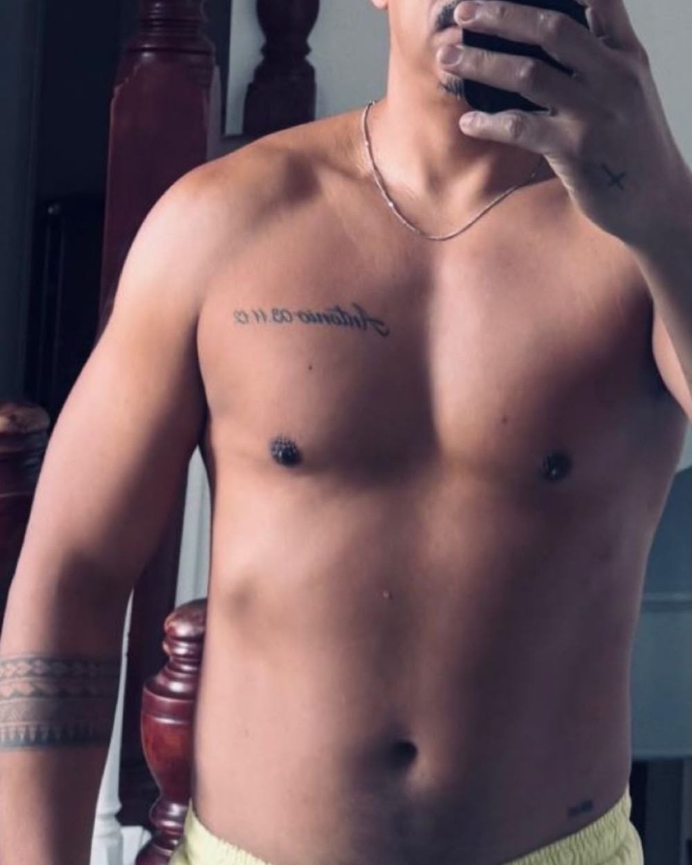 Client 1 before coaching: mirror selfie from chest to waistband, softer chest and midsection